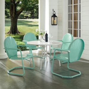 the dining table partners with four classic Griffith chairs. Each chair has a vintage style that comes in a variety of vibrant colors. The chairs cantilever base offer just enough flex for lounging in comfort. The simple dining table has a sturdy pedestal base that that allows the stunning Griffith chairs to shine.