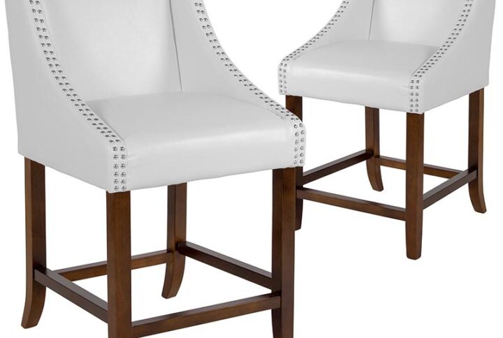 Bring warmth and comfort to your home while adding some world class elegance with this set of 2 classically sophisticated white counter stools. Have breakfast at your kitchen island or hang out with friends around the dining room table in style. Boasting soft and durable LeatherSoft upholstery paired with decorative nail head trim