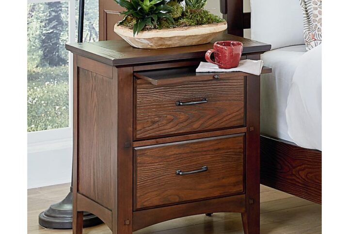 The Modern Mission Collection is an updated version of the traditional Craftsman design. The renewed look has enhanced darker hues in the finish with a deep oak grain look and feel. The five step finishing process is perfectly accented by the beauty of the new gunmetal hardware. Two deep storage drawer offer sizeable space for clothing and accessories. Both storage drawers open and close easily on metal side glides and is accompanied by a pull out tray that safely secures beverages. The Modern Mission nightstand creates a safe haven for the most valuable possessions.