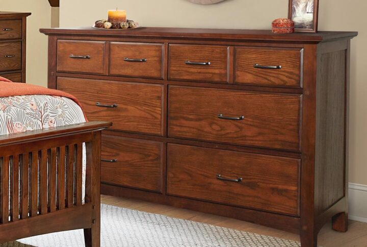 The Modern Mission Collection is an updated version of the traditional Craftsman design. The renewed look has enhanced darker hues in the finish with a deep oak grain look and feel. The five step finishing process is perfectly accented by the beauty of the new gunmetal hardware. The felt lined top drawers are helpful for storing away jewelry or delicates and the four deep storage drawers offer sizeable space for clothing or accessories. All drawers have heavy duty metal side glides for ease of opening and closing. Help ensure your morning preparations with the Modern Mission six drawer dresser.
