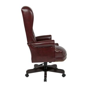 Deluxe High Back Traditional Executive Chair. Thick Padded Seat and Back with Built-in Lumbar Support. One Touch Pneumatic Seat Height Adjustment. Locking Tilt Control with Adjustable Tilt Tension. Jamestown Oxblood Vinyl (-JT4). Mahogany Finish Wood Covered Steel Base with Dual Wheel Carpet Casters.