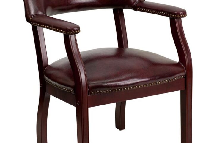 Add timeless charm to your space with this elegant reception/conference chair. This chair features oxblood vinyl upholstery