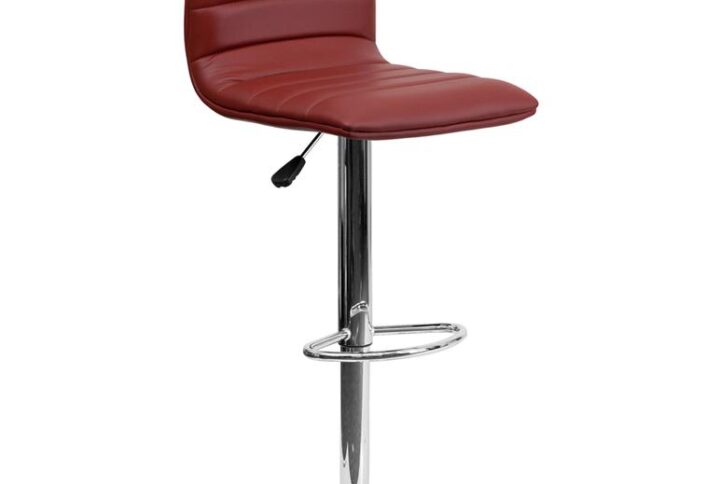 Provide the perfect pop of color and on-trend appeal in your home with this burgundy adjustable barstool. This modern style armless stool has a gracefully contoured shape and mid-back design that offers the perfect amount of support for guests. The height adjustable swivel seat adjusts from counter to bar height with the handle located below the seat. The chrome footrest supports your feet and promotes good posture while also providing a contemporary chic design. To help protect your floors