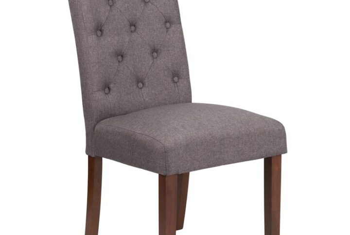 The classic design of this gray fabric upholstered parsons chair makes it a versatile seating option for your home. Button tufted detailing and a mahogany frame finish make them beautiful while high density foam padding and solid hardwood frame construction make them comfortable and durable. Parsons chairs are versatile and can be used not only in the dining room and kitchen but also as a reading chair or extra seating in the living room. The armless design gives the illusion of space which makes them great for small spaces. Vacuum or brush lightly to remove soil. Skirted chair covers can be used to soften their lines for living rooms and bedrooms. A parsons chair can be both formal or casual and are designed to go with almost any decor.