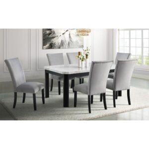 Dine in luxury with the Solano Dining 7-piece set by Cambridge. This modern contemporary dining set serves any occasion from a casual lunch in an elegant breakfast nook to a family dinner in your formal dining room. The white marble tabletop features beveled corners and natural veining - no two are exactly alike! Foam-filled chair backs and seats covered in soft gray velvet are finished with chrome nailhead detailing. Ebony black wood frames offer striking contrast for a bold statement. Crafted from solid Acacia and rubberwood