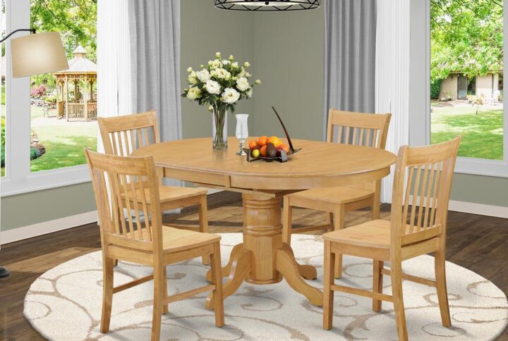 The dinette table set is a 5-piece set of gorgeous small kitchen table with a stronger carved pedestal support. The Beveled oval table completes with four robust dining chairs that create warm and comfortable kitchen space environment. The whole 5-piece table and chairs set material is wood with a fancy Oak finish; the dining chairs offer sophisticated carvings with microfiber upholstery providing sufficient support