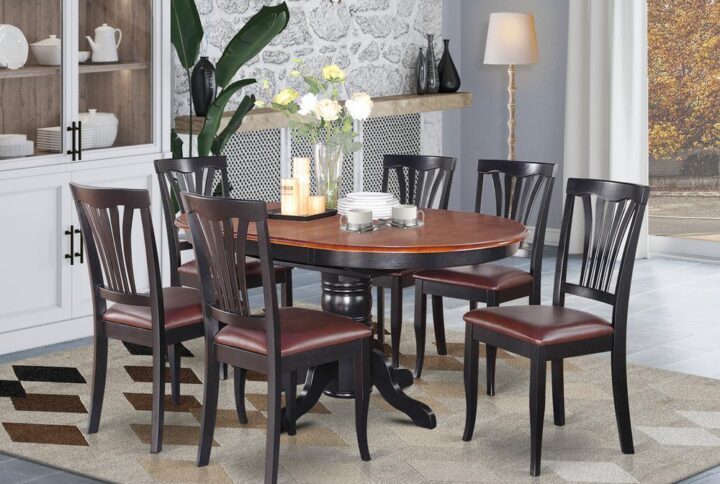 The dinette table set with integrated self storing extendable leaf which fits four to six people.Sleek solid wood table top with sturdy carved pedestal support. Beveled oval design for warm and comfortable kicthen space atmosphere Finished in rich Black & Cherry color