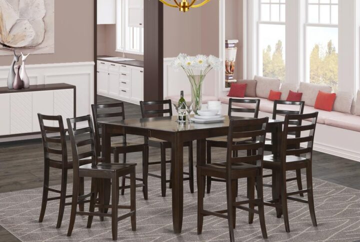 Counter height sets gives a traditional style having square counter height dining table and chairs that feels at home either in a working kitchen area or elegant dining room. Table and chairs have a luxurious sleek finish combined with beveled edges. In comfort seats your friends and relatives with the dining room table built in self storage extension leaf. Square counter height dining table is fastened to 4 dependable corner posts for plenty leg room. Bar stools have ladder back style equipped with smooth and calming solid wood seats. Finished in pleasant Cappuccino colors.