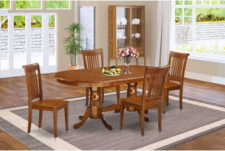 This Plainville dining room table set possesses a fabulous finish that has a countryside laid-back impression. Merging the easy care of a smooth solid wood dining room table top with classic fashioned legs for the distinctive look. The sleek oval small kitchen table top