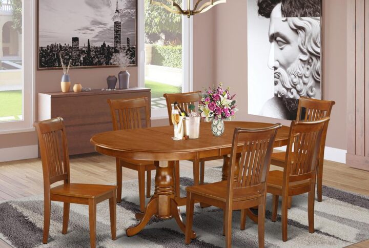 This Plainville dining table set boasts a fabulous finish that has a countryside laid back ambiance. Combining the simple care of a simple hardwood kitchen dinette table top with traditional styled legs for the personal look. The clean oval small kitchen table top