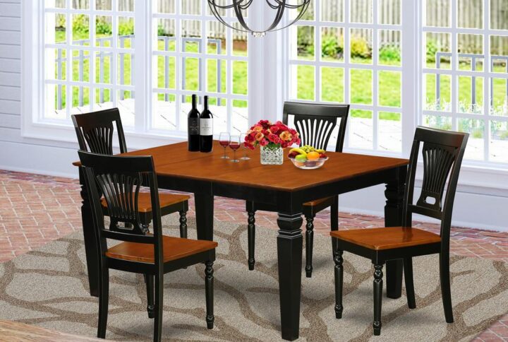 Harmonizing Black And Cherry Color Solid Wood Dinette Set With Basic Beveled Edge On Trim. Vintage Rectangle Dining Table With Four Legs. Recessed Details On Small Kitchen Table And Kitchen Dining Chair Legs For Added Support And Elegance. Beveled Chiseling On Legs Of Matching Table And Chairs.  Dining Table Featuring 18 In Self Storage Extendable Leaf In Dining Area Center Well Suited For Casual Or Formal Atmosphere. 5 Piece Dinette Set With One Weston Dining Room Table And 4 Solid Wood Seat Dining Area Chairs Finished In A Distinctive Black and Cherry Color.