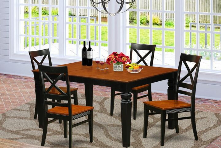 Coordinating Black And Cherry Color Hardwood Table And Chairs Set Having Basic Beveled Edge On Trim. Classic Rectangular Table Having 4 Legs. Recessed Details On Kitchen Table And Kitchen Dining Chair Legs For Added Support And Beauty. Beveled Carving On Legs Of Matching Table And Chairs. Kitchen Table Having 18 In Self Storage Extendable Leaf In Dining-Room Centre Suited To Casual Or Formal Atmosphere. 5 Piece Kitchen Set With 1 Weston Kitchen Table And Four Wood Seat Dining-Room Chairs Finished In A Luxurious Black and Cherry Color.
