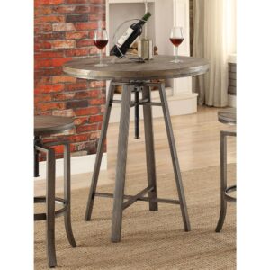 the table features a round tabletop in a wire brushed nutmeg finish that lends depth and detail. Angular legs are supported with a pair of cross braces and industrial-inspired metal hardware. Enjoy a glass of wine at the end of a long day or grab a quick bite before heading out on a Saturday morning. Consider adding the matching stool