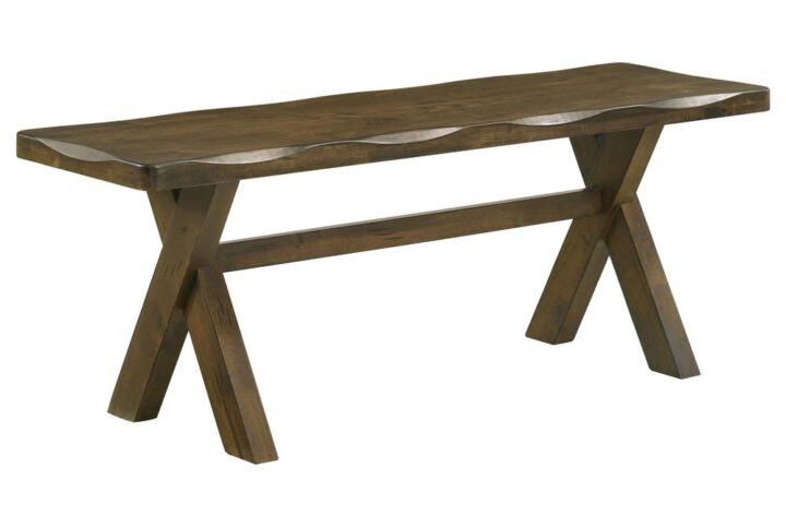 This wooden bench has a simple silhouette that exudes no-nonsense appeal. It makes a handsome addition to a dining area with a traditional country decor. Designed with worn edges and a knotty nutmeg finish