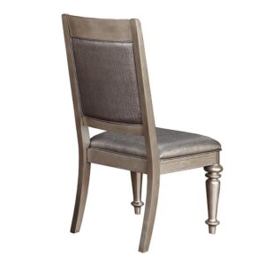 this side chair is a glamorous addition to a regal dining room. Metallic leatherette adds another layer of dimensionality