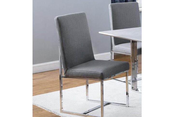 Fresh grey upholstery highlights the design-forward look of this dining chair. Bring comfort and classic styling to a glass or wood table. A high back with linear design elements offers minimalist
