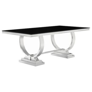 This dining table has a unique design that's an ideal complement to a contemporary style home. Large rectangular top is finished in black with silver edges. Silver legs are fashioned in a ring-like circular design atop two silver tiered bases. With a set of well-made chairs