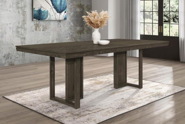 Take your dining experience to new heights with our chic transitional table. The sleek dark grey finish