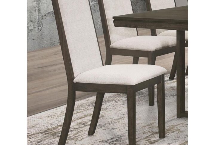 Experience luxurious comfort while dining with our beige upholstered side chairs. The chic dark grey finish perfectly complements the subtlety and elegance of our transitional dining set. These chairs not only offer a stylish seating option but also provide a cozy and inviting atmosphere. Elevate your dining experience with these exquisite side chairs that effortlessly blend comfort and sophistication.