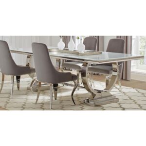 all of which boast a gleaming chrome finish that reflects the dining room's color palette like a chic mirror. Available within this same collection are a delicate light pink and grey slipper style dining chairs