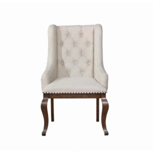 the chair features sloping arms that draw the eye and offer superb comfort and support. Its button tufted back lends classic style. Nailhead trim creates definition while adding a touch of charming character. A transitional design