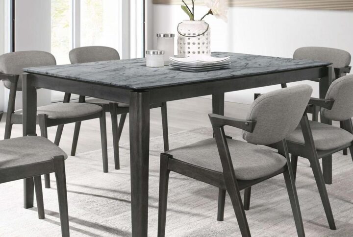 Gather around this mid-century modern dining table for a casual dining experience. Designed with a faux marble top that offers extra resistance to stains and the like