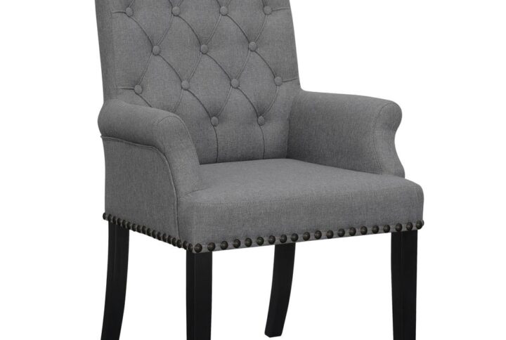 Cap the ends of your formal dining table with this transitional armchair for a classical flair. An elegantly rolled backrest paired with rolled armrests