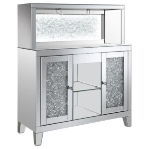 This wine cabinet is a striking statement piece that features a highly reflective surface made of mirror tiles and trim. The faux diamond encrusted doors and crystal knobs add a hint of sparkle while the open back shelf emits a soothing glow. This spacious rectangular frame is perfect for creating a dramatic effect on any focal wall.