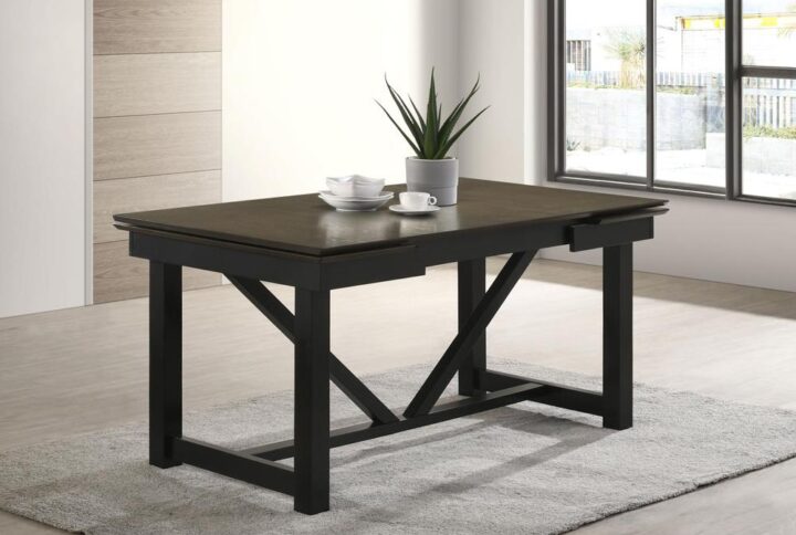 Embrace the timeless appeal of transitional style with our sleek dining table. The two-tone oak and black trestle base effortlessly enhance any décor