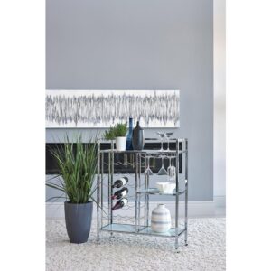 it's the perfect addition to a wine lover's home. Sleek metal lines in a gleaming chrome finish give it a polished look that exudes sophistication. Three tempered glass shelves with opulent marble patterns add to the stylish design. This contemporary bar cart is complete with attached casters to roll refreshments smoothly from guest to guest.