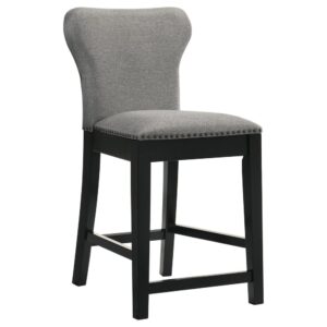 this wingback-inspired stool offers a comfortably seat for elevated dining spaces. A deep black finish frame and tapered legs offer a grounding visual effect