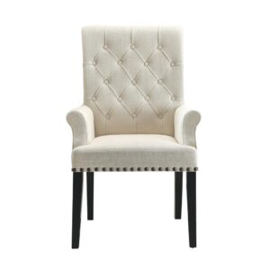 Seat guests in ultimate comfort. This dining arm chair represents an artful upgrade to modernize a casual space while preserving traditional charm. Lovely beige upholstery infuses light and a fresh ambiance. Button tufting on its seat back joins sleek nailhead trim to add captivating accents. Dark finished legs provide the perfect contrast to complete a fabulous design package.