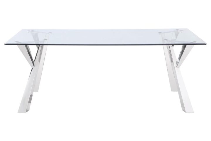 Sculptural style instantly elevates the modern glam aesthetics of a contemporary dining table. The rectangular table is topped with beautiful clear glass