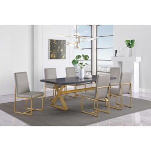 but updated in metal construction. The aged gold finish creates a striking contrast with the dark table top