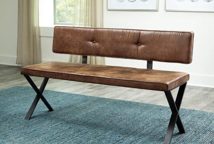 This gorgeous upholstered bench is crafted in warm tones and materials for a rustic appeal. It offers a vintage industrial allure from a warm
