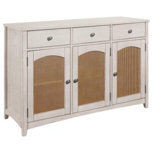 designed with three natural paper cane panel cabinet doors and a rustic off white finish throughout its elegant boxy frame. Round metal pulls adorn the top three drawers and bottom cabinet doors