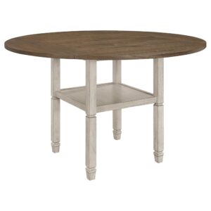 A relaxing farmhouse vibe proves decorative as well as comfortable in a seven-piece round counter height dining set that puts your sense of style on display with easy colors and a cottage-inspired motif. This set begins with a round table built of rustic cream finish wood legs and a nutmeg finish wood top showing natural woodgrain markings