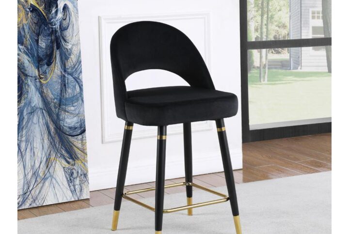 This set of two counter height stools features an elegant bucket style seat that lends a retro-inspired Mid Century modern look. Each stool offers long-lasting