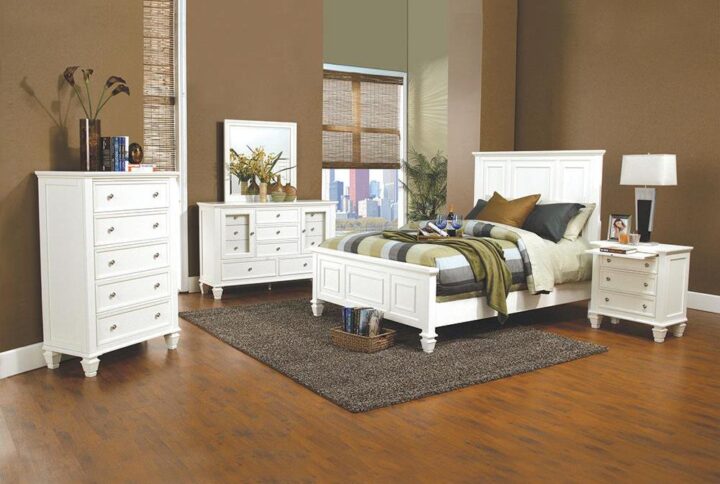 The Sandy Beach collection presents this splendid 4-piece bedroom set that offers a style that's both timeless and distinctive. The bed has a headboard and footboard that both feature exquisitely carved paneling. The nightstand has three drawers and a pull-out service tray for added convenience. The dresser features an array of different sized drawers and two doors that open up for access to the smaller drawers as well as room on top for the accompanying square mirror. Each piece is constructed from maple veneers in a brilliant buttermilk finish (also available in a timeless black finish).
