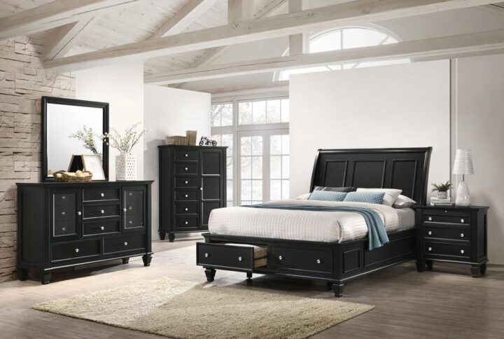 The Sandy Beach collection showcases this magnificent 4-piece bedroom set with style and function. The storage bed features a slightly flared headboard with carved paneling and a footboard with two built-in drawers. The adjacent nightstand includes three drawers and a convenient pull-out service tray that's sure to come in handy. The dresser is built with room on top for the square mirror and with ten drawers and two doors that open up to six smaller drawers for plenty of storage. All pieces are constructed from maple veneers in an exquisite black finish (also available finished in buttermilk).
