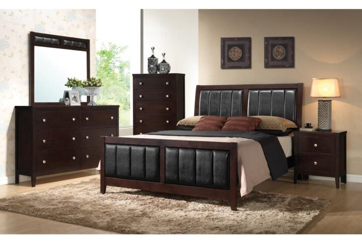 From the Carlton collection comes this handsome 5-piece bedroom set featuring padded black leatherette paneling throughout. The sumptuous padding on the bed is found on the headboard and footboard for a stately appearance. The nightstand and chest are characterized by deep drawers and spacious tops for a lamp or decorative vases. The dresser has six spacious drawers and enough space on for the accompanying mirror