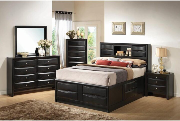 Update a bedroom with the open and geometric details from this California king storage bed. Add depth with the chamfered edge drawer fronts that line the simple silhouette. The headboard is full of clean lines and features drop down compartments and a shelf. making it perfect for a primary suite of any size. The frame and sleek black finish from this transitional design look great in any modern space. The footboard features four drawers while the right side has a drop down compartment compartments