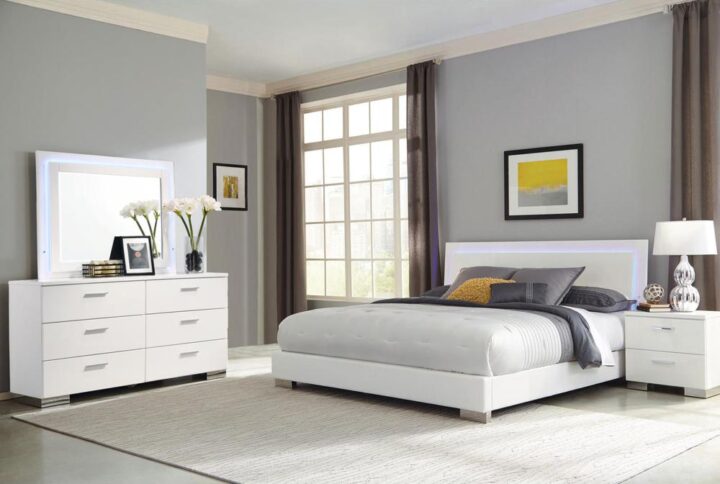 Add a bright and contemporary look to your master or guest suite with this chic bedroom set. Anchored with a bed featuring a straight-edge headboard with touch lighting