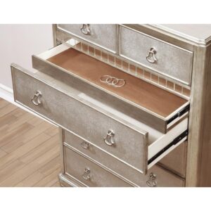 the crisp metallic platinum finish from this six-drawer chest completes a chic motif. Featuring a classic French country-inspired silhouette