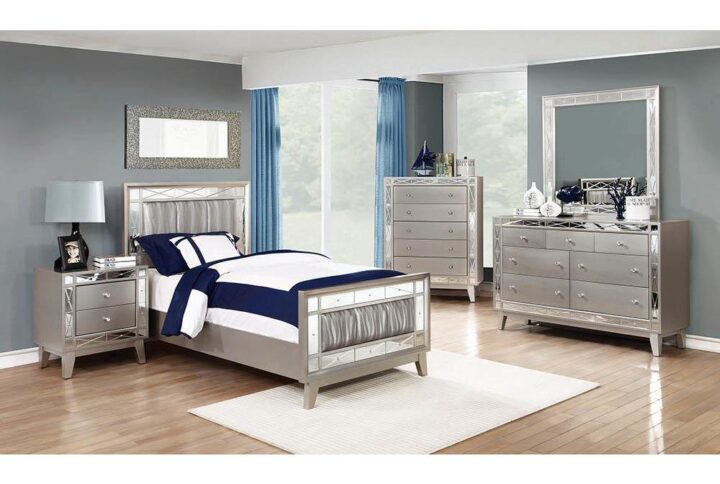 The Leighton collection presents this magnificent glam-style bed. It has an upgraded metallic finish that evokes images of sparkling mercury. The etched mirror-paneled accented frameworks features real mirrors for a mesmerizing effect. Wrapped in metallic leatherette with scintillating wave patterns. This bed is an absolute delight for the bedroom.