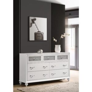 this modern dresser really stands out. The top drawer fronts are covered in sparkling acrylic panels for a stunning infusion of shine. Faceted crystal hardware takes elegance to the next level. Dainty turned feet add a classic element to its glamorous design. Available in finishes of black or white