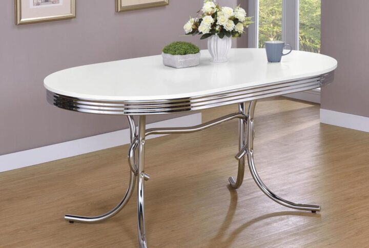 Evoke images of simpler times with the retro aesthetic of this chrome plated oval table. Distinctive styling and solid construction create durable glamour that enhances any dining experience. The table features a white finish and a chrome rimmed top. Add eye popping color to your dining room by adding either a red or black cushion on chrome plated chairs sold separately. Adding this ensemble to your home will create cherished memories for years to come.