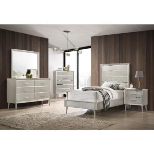 Update your bedroom to a glamourous modern space with a bedroom set from the Ramon collection. Mid-century modern lines get an unexpected dose of luxe style with metallic and mirrored finishes in this distinctive modern glam bedroom set. Beveled mirrored surfaces peek from behind textured metallic silver panels for a Hollywood look. Felt-lined top drawers protect your jewelry and keepsakes. Choose from a full range of bed sizes and furniture pairings to create the perfect modern glam bedroom.