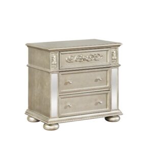 Keep necessities close at hand with this three drawer nightstand from the Heidi collection. The metallic platinum finish gives a glamorous look with mirrored accents. Three drawers offer ample space to organize those needed items. Ornate wood carved design offers additional intricate detail in this luxe nightstand. Pair two on either side of the bed for a symmetrical decor theme