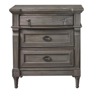 Upgrade the elegance of your home decor with the updated transitional design of this three-drawer nightstand. It features a gorgeous classic French neoclassical design reimagined for today. The stunning sand blasted wood finish with just the right amount of French grey is a pure delight. The drawers are crafted with antique silver metal finished pendant and ring pull hardware